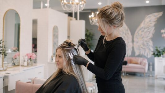 Colorist applying hair color at Halo Salon in Auburn, AL