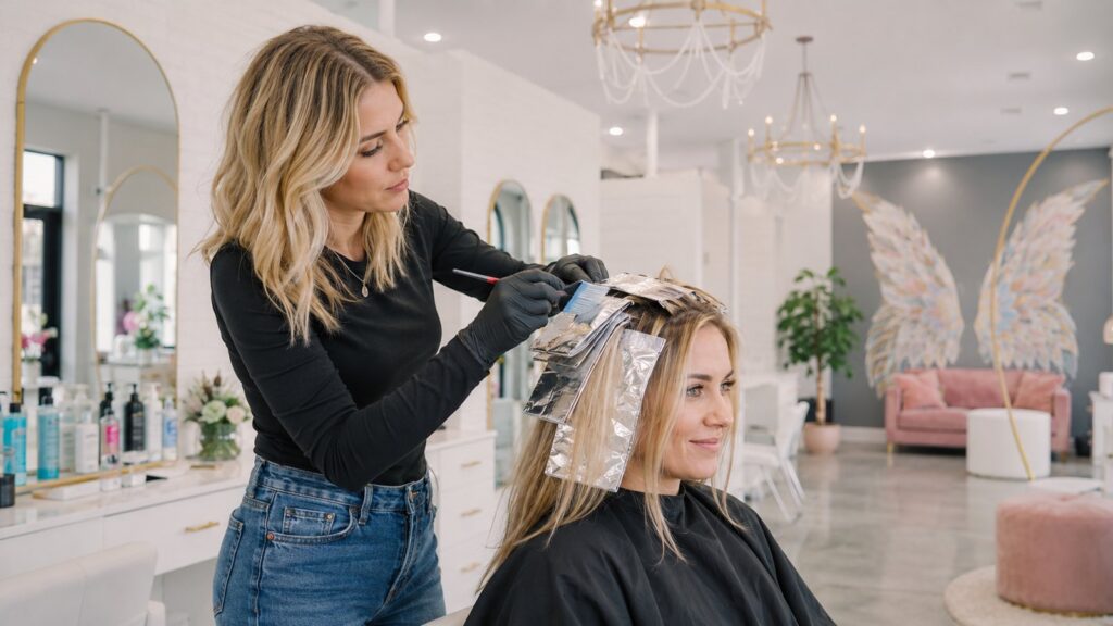 Colorist foiling highlights at Halo Salon in Auburn, AL