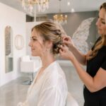 Stylist creating a special event updo at Halo Salon in Auburn, AL