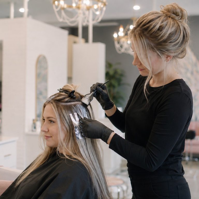 Colorist applying hair color at Halo Salon in Auburn, AL